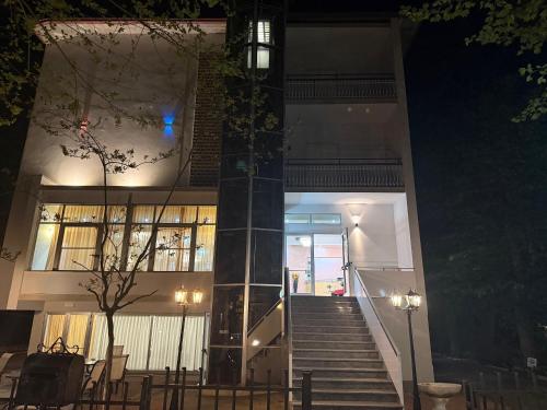 a building with stairs in front of it at night at Hotel Anny in Cervia