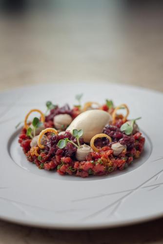 a plate of food on a white plate at Iris Porsche Hotel & Restaurant in Mondsee