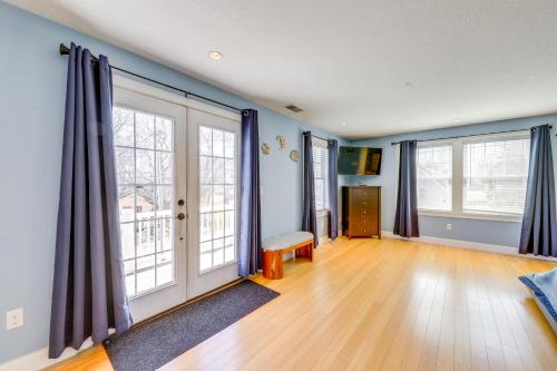 an empty living room with blue walls and large windows at Steps to Short Sand Beach Retreat with Game Room! in York