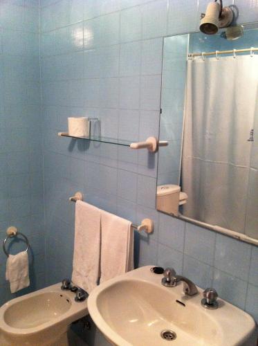 a bathroom with a sink and a shower and a mirror at Hotel Pinzon in Baiona