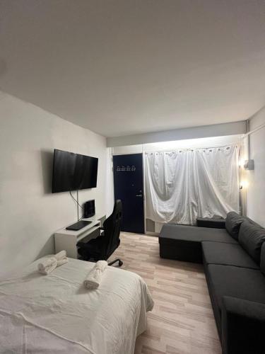a bedroom with a bed and a desk and a couch at Studio Apartment in Airport Area in Copenhagen