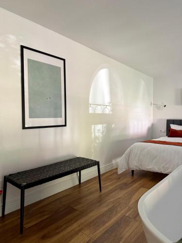 a bedroom with a bed and a table and a bath tub at Love&Loft central park with private garden in Baia Mare