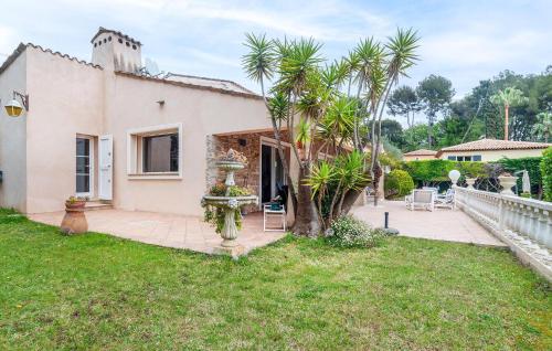 a house with a palm tree in the yard at Beautiful Home In Mougins in Mougins