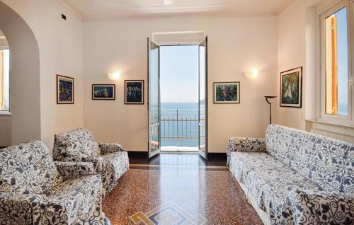 a living room with couches and a view of the ocean at 4 Bedroom Lovely Apartment In Camogli in Camogli