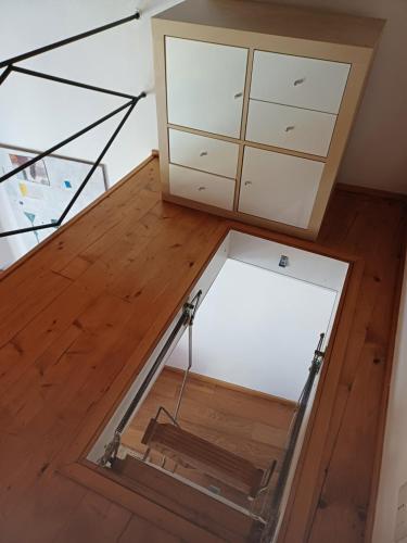 a room with a glass table and some drawers at CASA VISTA LAGO E GIARDINO in Porlezza