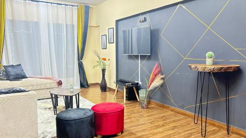 a living room with a couch and a table at Regal Suites in Athi River
