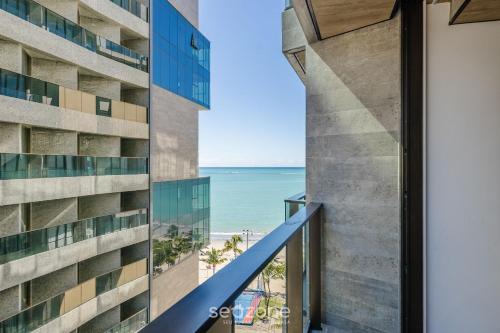a view of the ocean from the balcony of a building at NWTs - Estúdios em Prédio com Vista Mar in Maceió