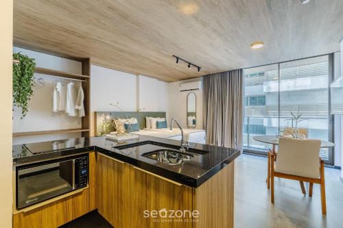 a kitchen with a sink and a counter top at NWTs - Estúdios em Prédio com Vista Mar in Maceió