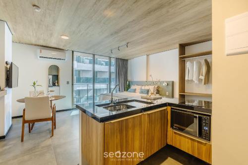 a kitchen with a sink and a counter top at NWTs - Estúdios em Prédio com Vista Mar in Maceió