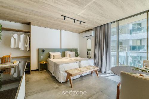 a bedroom with a bed and a large window at NWTs - Estúdios em Prédio com Vista Mar in Maceió