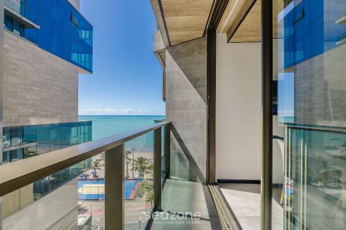 a view of the ocean from the balcony of a building at NWTs - Estúdios em Prédio com Vista Mar in Maceió