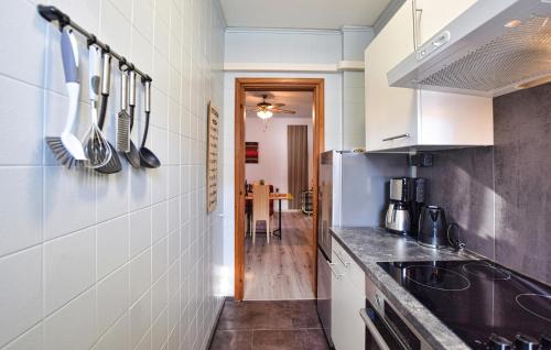 a kitchen with a sink and a counter with utensils at 1 Bedroom Lovely Apartment In Grado in Grado