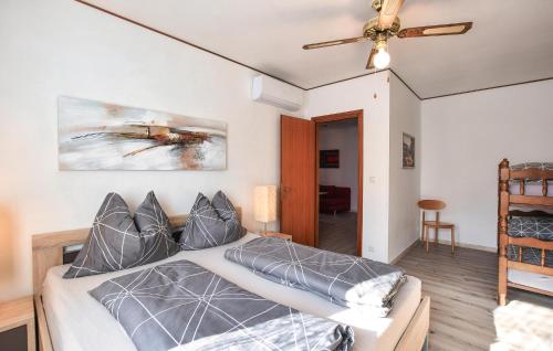 a bedroom with a bed and a ceiling fan at 1 Bedroom Lovely Apartment In Grado in Grado