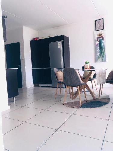 a living room with two chairs and a table at urban living in Fourways