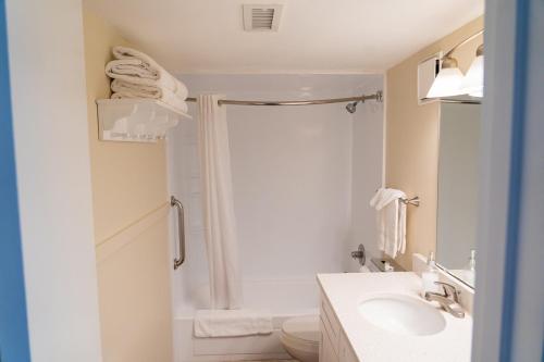 a bathroom with a shower and a toilet and a sink at Summer Sands - 303 by Sea Scape Properties in Wrightsville Beach