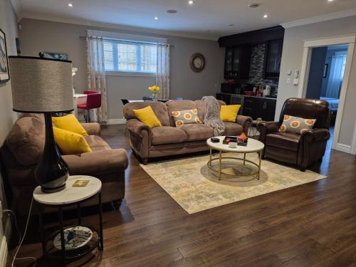 a living room with couches and a table at The Blue Jay Nest in Topsail