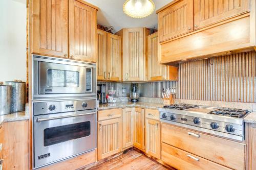 a kitchen with wooden cabinets and stainless steel appliances at Hot Tub and Yard Wills Place Utah Family Getaway in Glendale