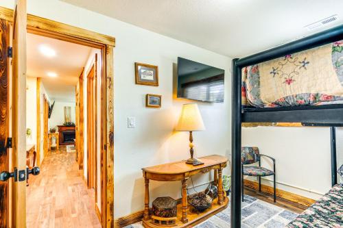 a bedroom with a bunk bed and a table with a lamp at Hot Tub and Yard Wills Place Utah Family Getaway in Glendale