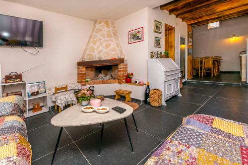 a living room with a table and a fireplace at House Moj mir in Primošten
