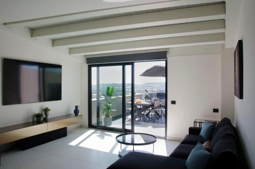 a living room with a couch and a table at Civico Savoia Apartment in Rosolini