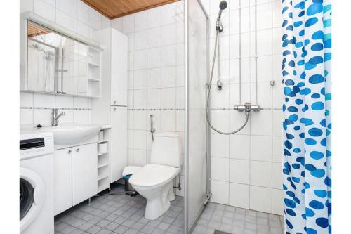 a bathroom with a toilet and a sink and a shower at Kotikaksio Grigio in Lahti