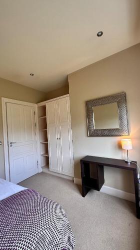 a bedroom with a bed and a mirror on the wall at Kelly G's in Feevaghmore