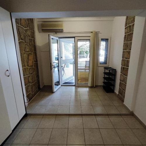 a hallway with a door and a tile floor at NEWBORN Hostel Budva in Budva
