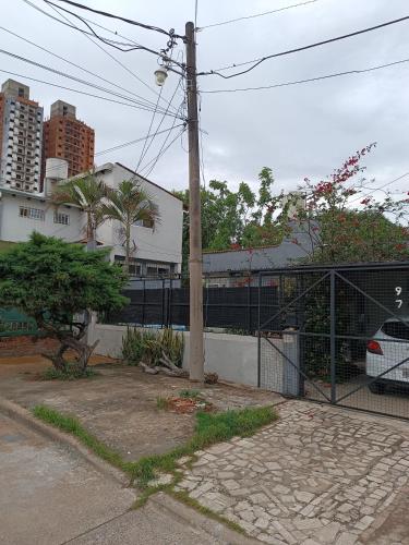 a fence with a pole in front of a building at Pasaje HOME 2 in Resistencia