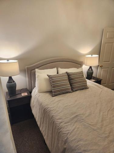 a bedroom with two lamps and a bed with two pillows at Schwartz Castle in Columbus