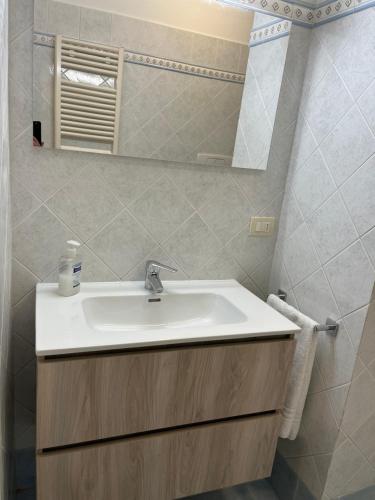 a bathroom with a sink and a mirror at Holiday House La Fornace in Pontedera