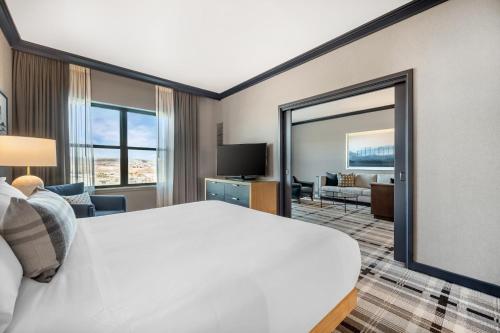 a hotel room with a bed and a large mirror at Omni Interlocken Hotel in Broomfield