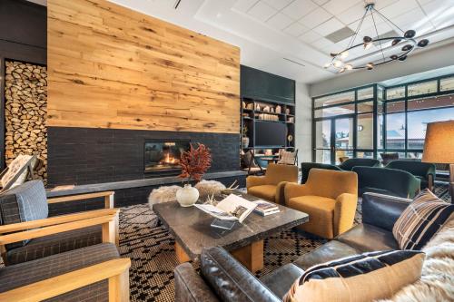 a living room with a fireplace and leather furniture at Omni Interlocken Hotel in Broomfield