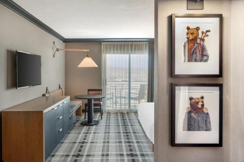 a hotel room with three pictures of dogs on the wall at Omni Interlocken Hotel in Broomfield