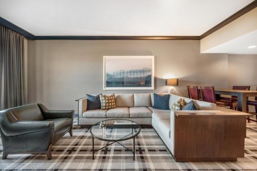 a living room with a couch and a table at Omni Interlocken Hotel in Broomfield