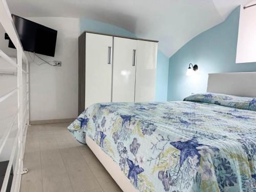 a bedroom with a bed and a tv in it at Giamè House Ischia in Ischia