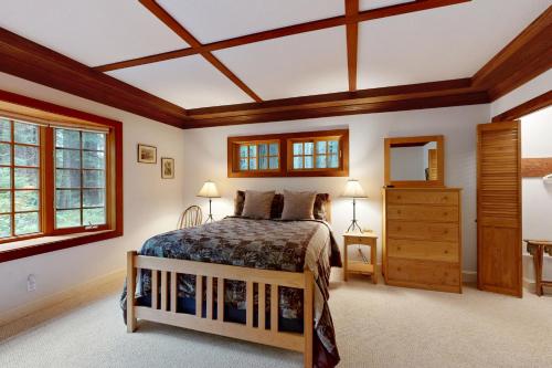 a bedroom with a bed and a wooden ceiling at Little River Redwoods in Little River