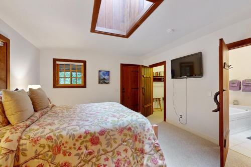 a bedroom with a bed and a tv and a tub at Little River Redwoods in Little River