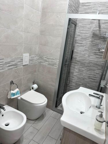 a bathroom with a toilet and a sink at Giamè House Ischia in Ischia