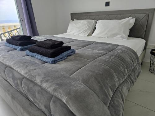 a bed with towels sitting on top of it at Villa Amavi Peyia in Peyia