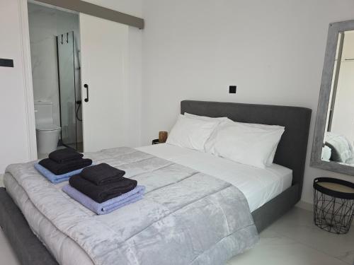 a bedroom with a bed with two towels on it at Villa Amavi Peyia in Peyia