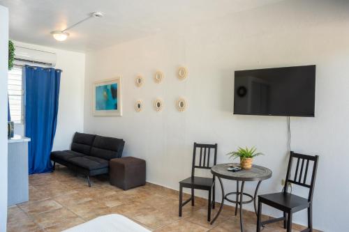 a living room with a couch and a table and chairs at Ocean Village at Combate in Cabo Rojo