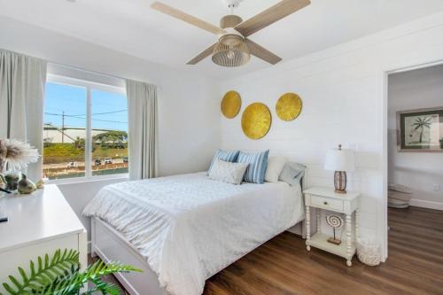 a white bedroom with a bed and a ceiling fan at Luxury Ocean View Condo Steps To The Sand VIEWS in Manhattan Beach