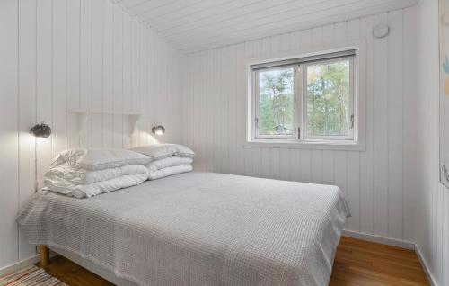 Una cama o camas en una habitación de Awesome Home In Nexø With Sauna