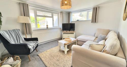 a living room with a couch and a tv at Joannes Retreat, Dog Friendly Property in Weymouth with Free Parking in Weymouth