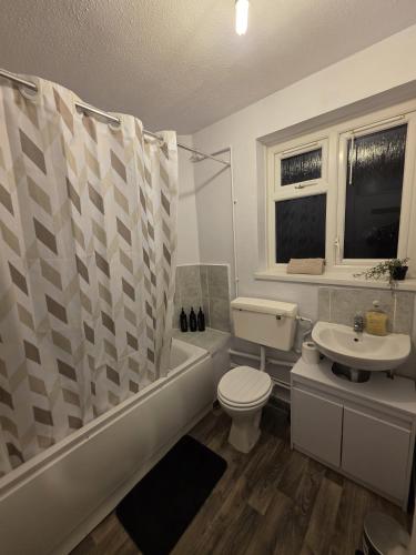 a bathroom with a toilet and a tub and a sink at Totteham stadium in London