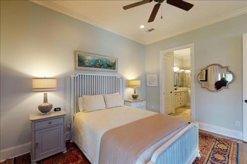 a bedroom with a bed and a ceiling fan at Garden Cottage 10 in Jekyll Island