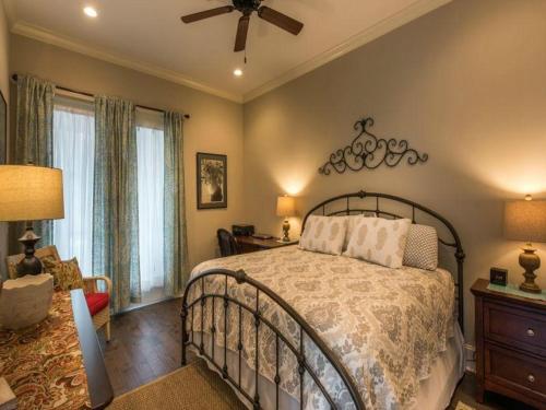 a bedroom with a bed and a ceiling fan at Garden Cottage 08 in Jekyll Island