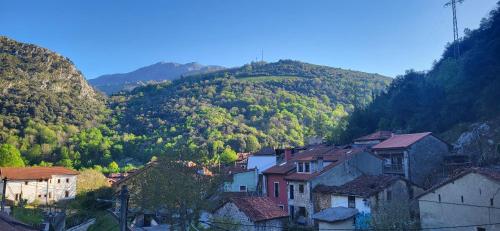 a group of houses in front of a mountain at Ca Na Daniela in Carreña de Cabrales 