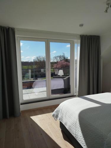 Penthouse avec vue - Durbuy - Hotton - La Roche en Ardennes - Han sur Lesse - Lumineux - Terrasses - Parking - Grand jardinにあるベッド