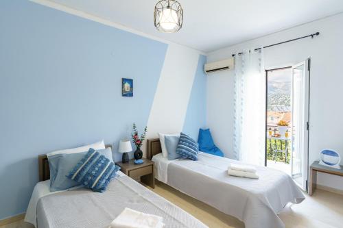 a bedroom with two beds and a window at S K apartments K in Argostoli